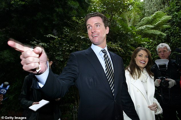 California Governor Gavin Newsom (left) is photographed with is wife Kimberly Guilfoyle (right) while he was running for mayor of San Francisco in 2003. The couple married in December 2001 and announced their divorce in January 2005