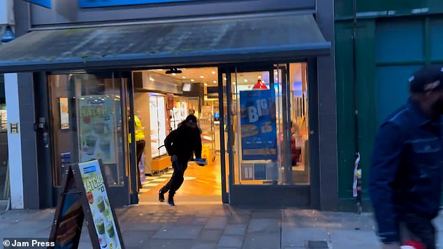 One of the attacker's friends brazenly dashed off with a food item from the Croydon shop