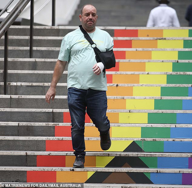 Ahmed al-Ahmed descends the rainbow stairs after visiting 25 Martin Place for a two-hour appointment in the building's upper floors occupied by lawyers and financial advisers
