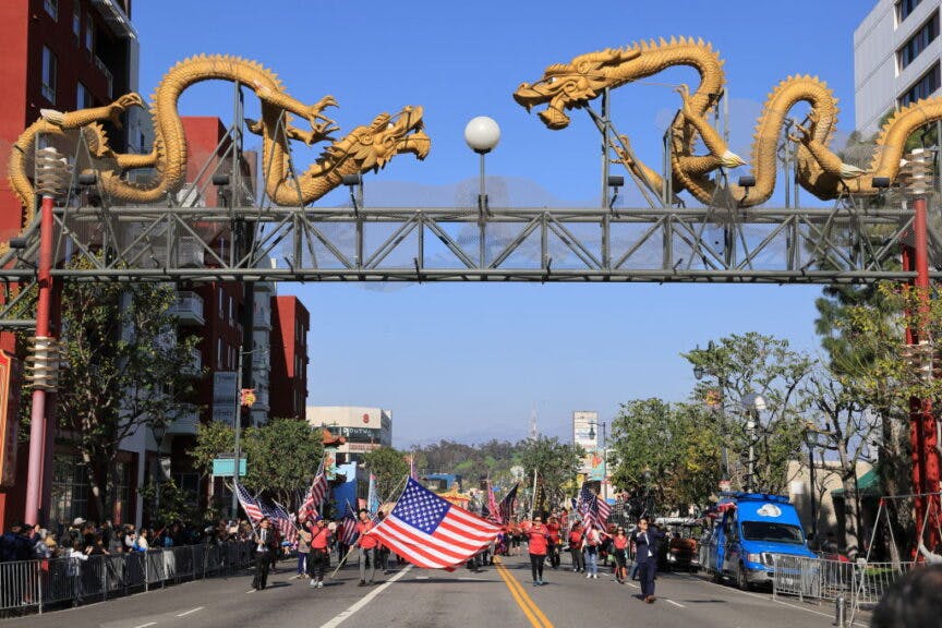 LOS ANGELES, CALIFORNIA - JANUARY 28: People holding national flags of the United States attend a parade celebrating the Chinese Lunar New Year, or the Spring Festival, at Chinatown on January 28, 2023 in Los Angeles, California. (Photo by I RYU/VCG via Getty Images)