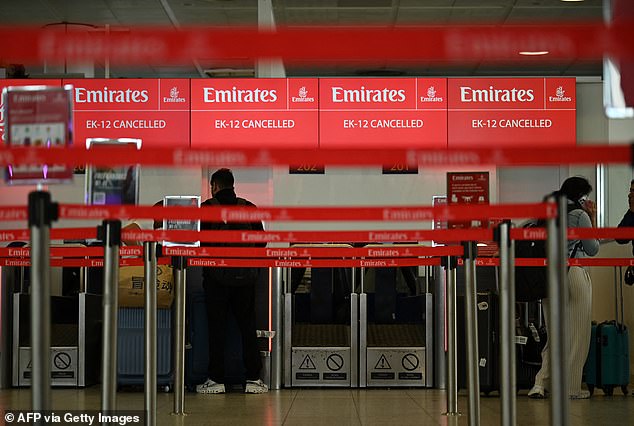 A check-in desk shows information on a cancelled flightas thousands of passengers remain stranded following the air strikes in Iran