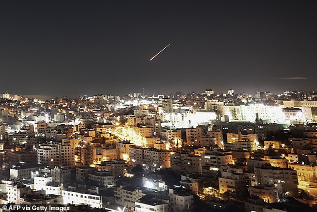 An Iranian projectile leaves a trail in the sky as seen from the Israeli-occupied West Bank city of Hebron early on March 1, 2026