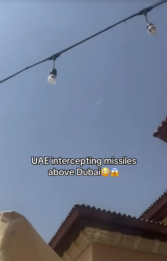 In one video, a Brit can be heard saying, 'That's three missiles, over our heads,' while focusing on the white missile streak above