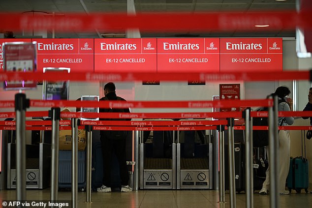 After the UAE's airspace was closed, many flights heading to Dubai were forced to return to their starting points. Pictured: A check-in desk showing information on cancelled Emirates flights at London Gatwick Airport on Saturday