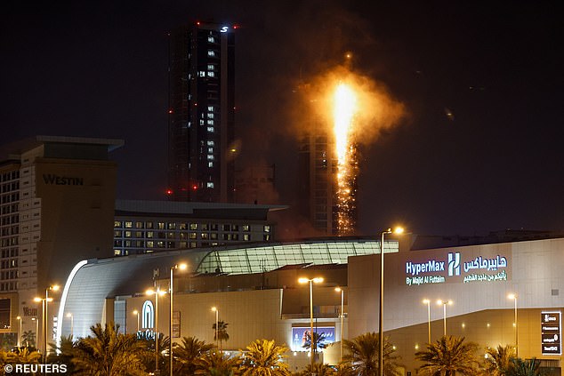 Smoke rises from a burning building in Bahrain, believed to be the luxury apartment building Era View Tower hit by an Iranian drone strike