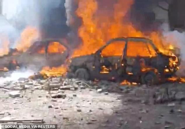 Vehicles burning in Tehran on Saturday after air strikes by Israel and the US
