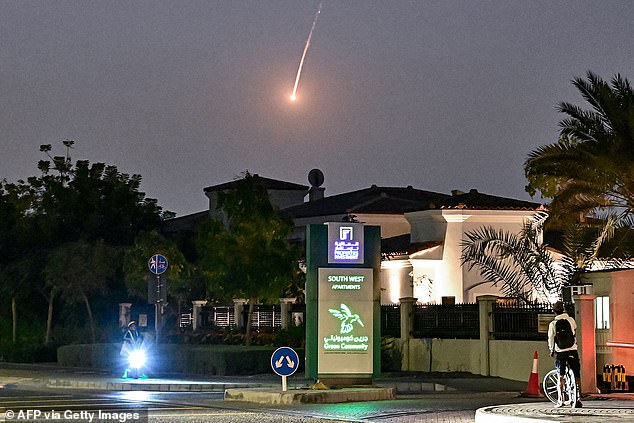 A cyclist watches in horror as a supersonic missile launched by Iran falls over Dubai