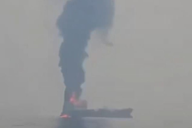 An oil tanker burns off the coast of Oman after being attacked, with four of the crew injured