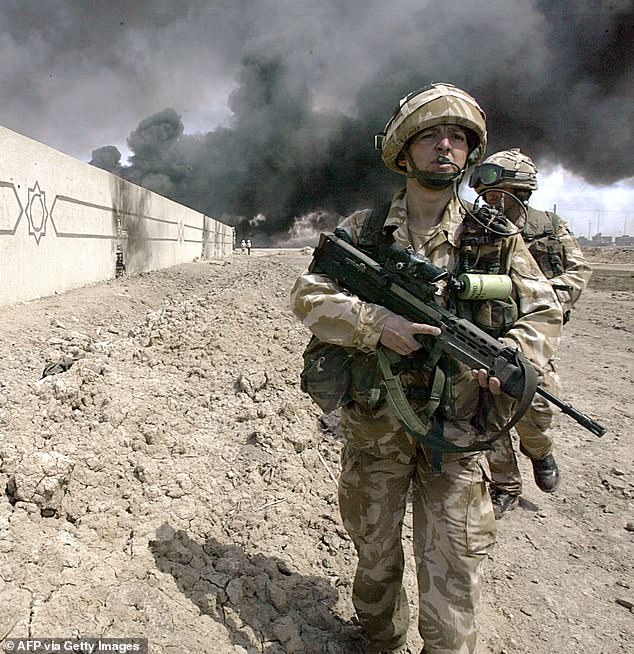 Pictured: British Army soldiers are seen out on patrol in Basra, Iraq, in April 2003