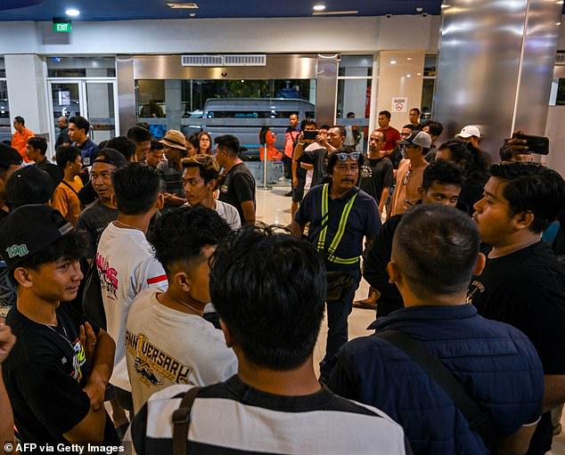 Family members and relatives of those onboard are pictured waiting for updates on the search and rescue operation