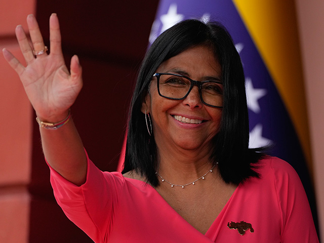 Title: Venezuela Colombia Image ID: 26114638830908 Article: Venezuela's acting President Delcy Rodriguez waves as she waits for Colombian President Gustavo Petro at Miraflores Palace in Caracas, Venezuela, Friday, April 24, 2026. (AP Photo/Ariana Cubillos)