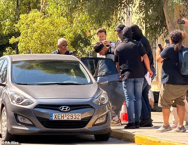 Ahmadzai was pictured being led out of the Athens Court House complex in Kypseli after a hearing on Wednesday