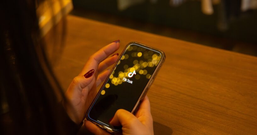 TikTok is displayed on a smartphone screen in this illustration photo in Corsica, France, on March 12, 2026.