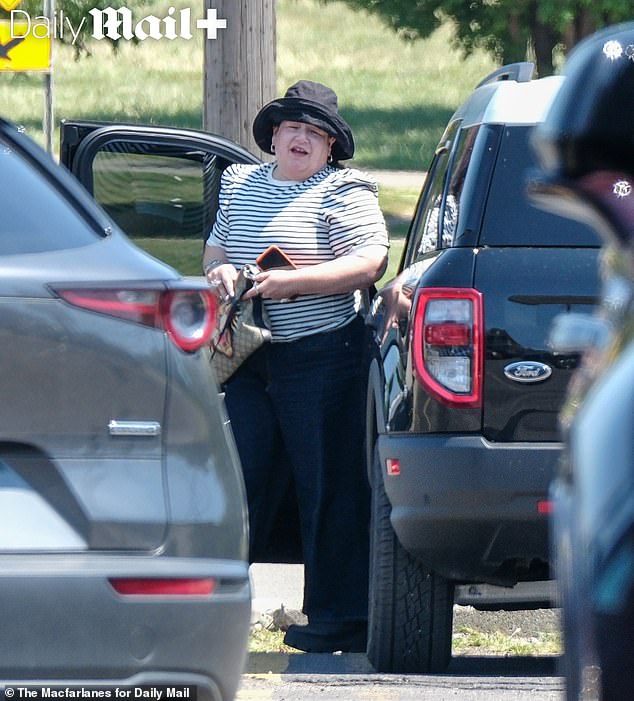 The former rock star wore a white striped shirt and carried a Gucci bag for her lunch