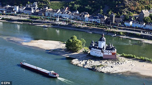 A passenger ship passes the Castle Pfalzgrafenstein on the Rhine River in Kaub, Germany, August 6, 2026