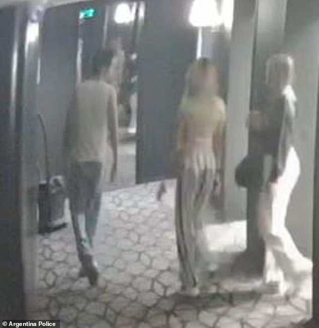 Liam is seen with the two call girls in the hallway of the hotel as he takes them to his room