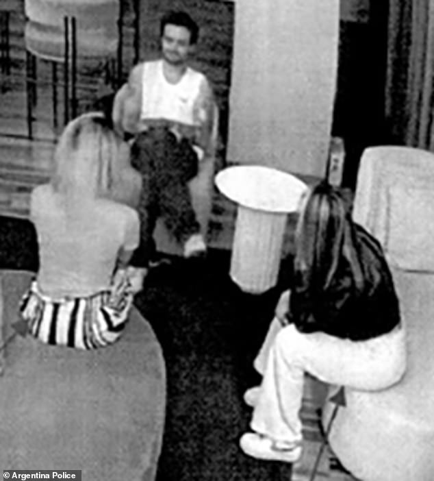 Liam chatting with the two prostitutes in the hotel