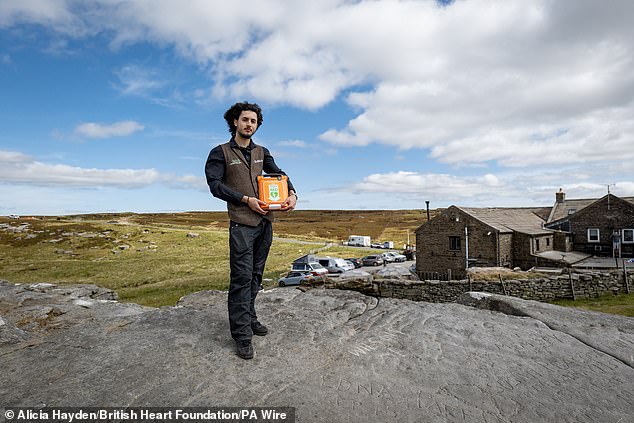 Famous for being the UK's highest pub, the country's highest defibrillator is also located at the Tan Hill Inn in Swaledale, North Yorkshire. Sitting at 1,732 feet above sea level, the 400-year-old pub which has hit the headlines for having punters snowed in during the depths of winter, also houses this notable defibrillator. Pictured here with inn employee Max Watson.