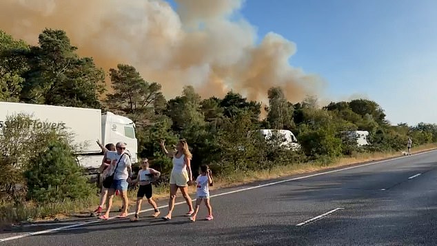 Smoke billowed from the trees next to the road on Sunday afternoon as motorists abandoned their cars