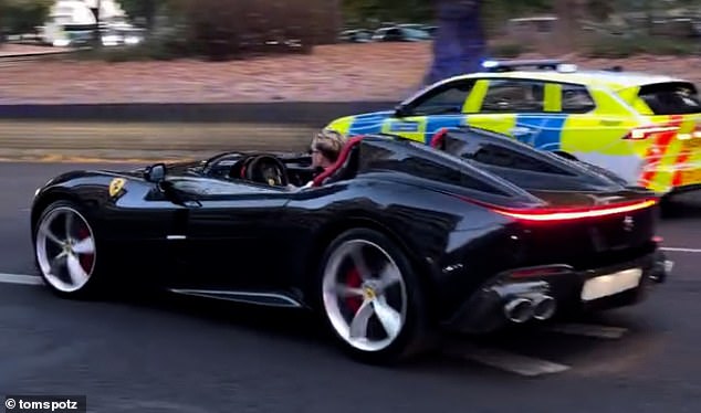 Accompanied by a police escort the officer donned his shades behind the wheel of the car