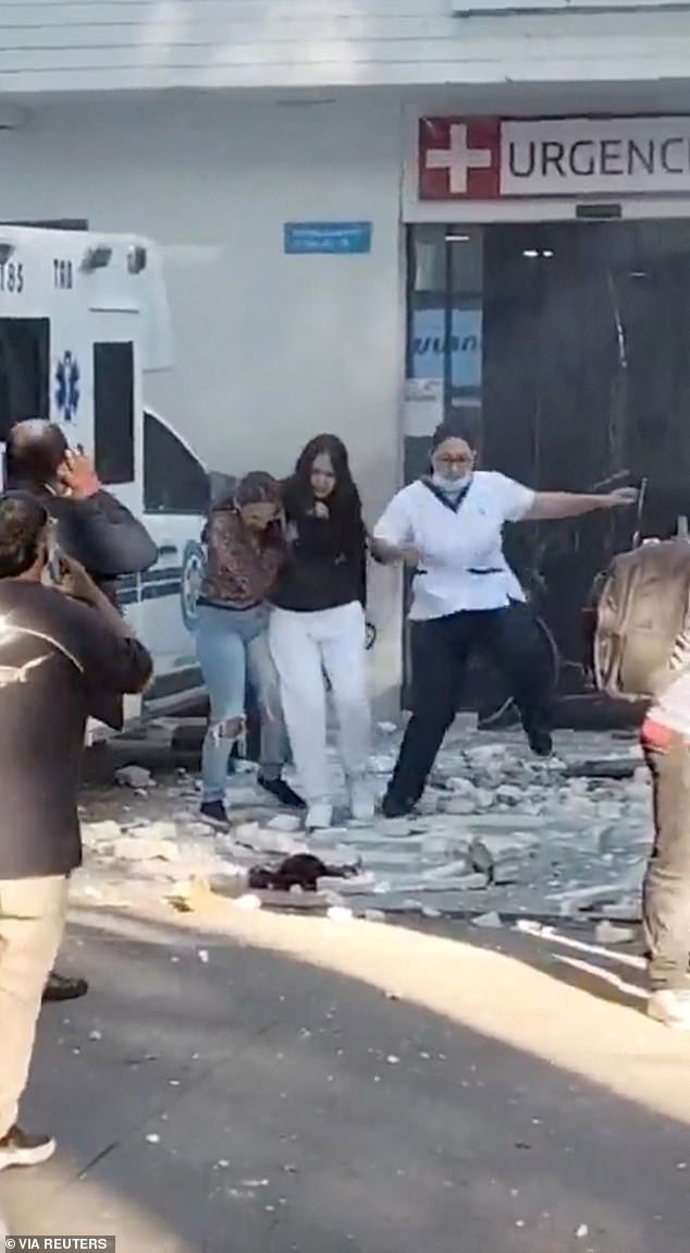 People run out of the hospital building during an earthquake in Cali, Colombia, on August 10, 2026