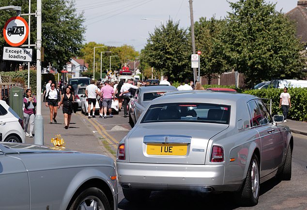 Luxury cars line the streets for the procession causing traffic to pile up