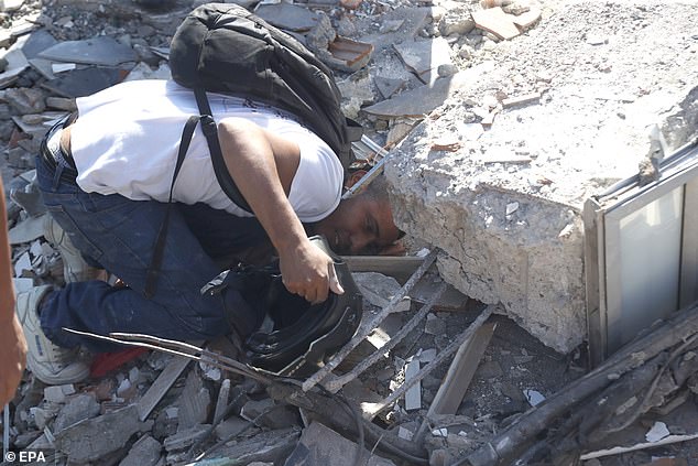 A person searches through the rubble of a collapsed building after an earthquake in Cali, Colombia, August 10 2026