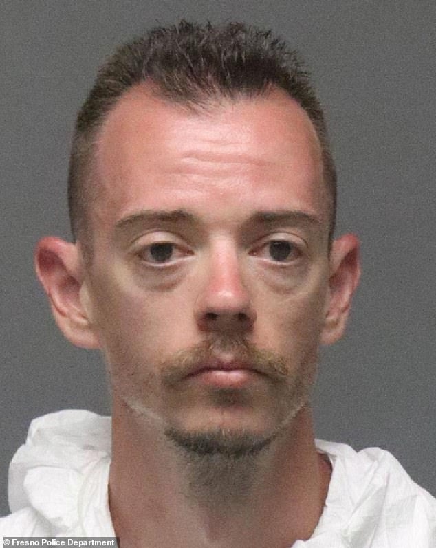 Michaels in his mugshot after he handed himself into police