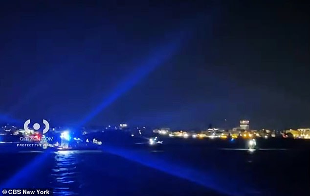 The 21-foot boat, which typically has a capacity limit of about ten people, was carrying 14 when it flipped. Above, emergency services on the water after the capsize