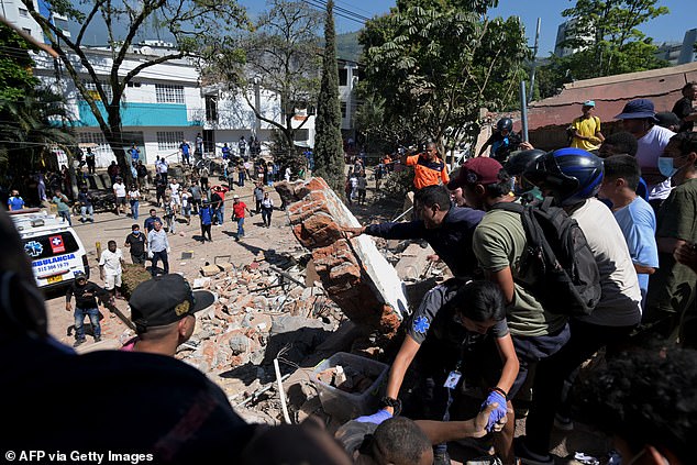 People look for survivors amid the rubble of a collapsed building after an earthquake in Cali, Colombia on August 10 2026