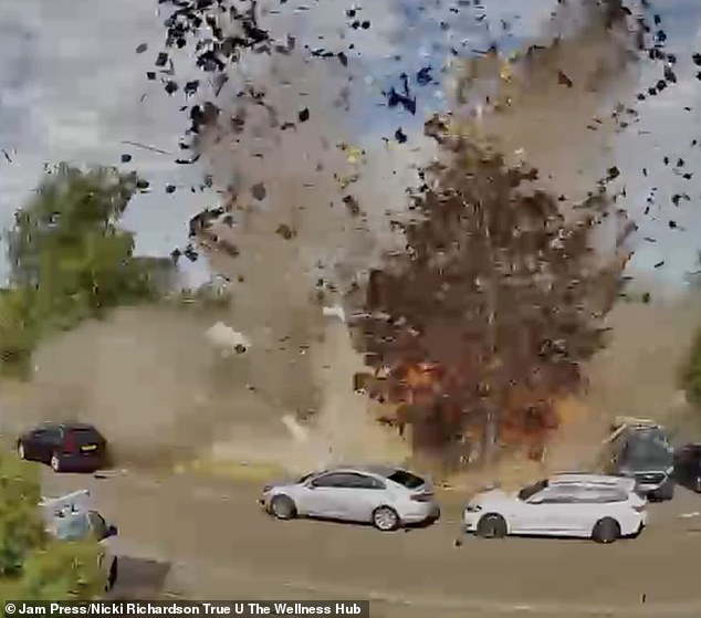 Footage shows bricks and debris flying out on to the street, damaging nearby homes and cars