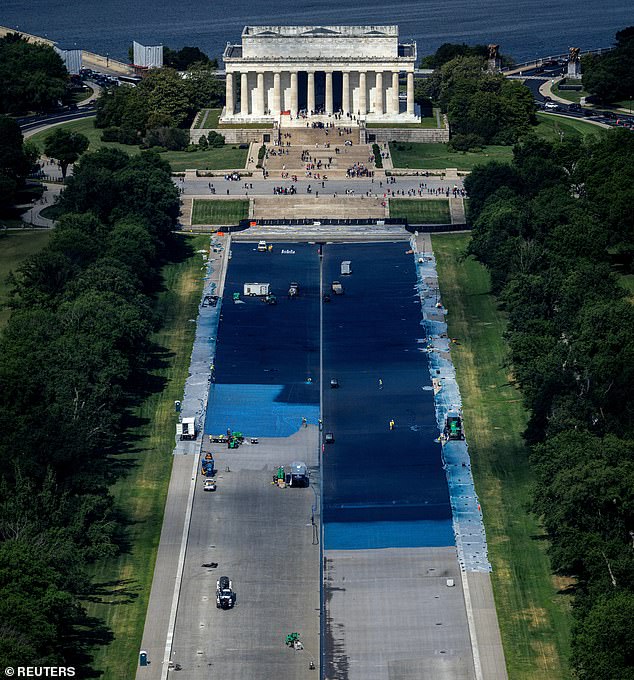 Workers paint the Reflecting Pool blue on May 14, 2026 under the directive of President Trump