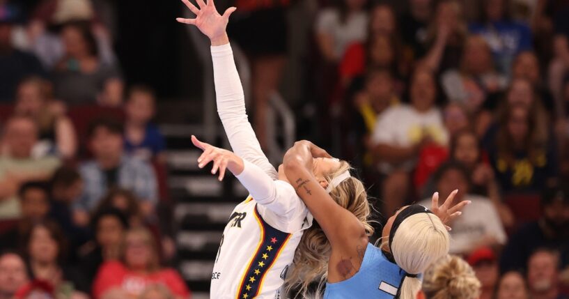 Sophie Cunningham of the Indiana Fever is fouled by DiJonai Carrington of the Chicago Sky during the first half at United Center on Aug. 8, 2026, in Chicago, Illinois.