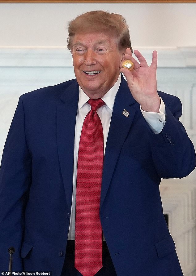 Trump pictured at last week's roundtable, holding a gold replica of a deep-sea nodule