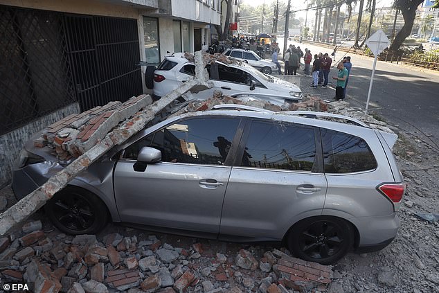Vehicles damaged by a collapsed wall are seen following an earthquake in Cali, Colombia, August 10 2026