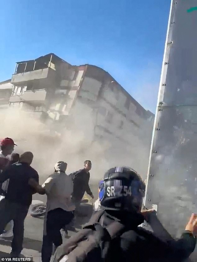 People watch as a building collapses during an earthquake in Pereira, Colombia, on August 10 2026