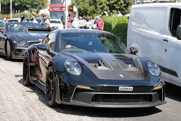 A fleet of supercars lined the west London roads as onlookers watched on. Dozens of friends and family members have turned out for the occasion