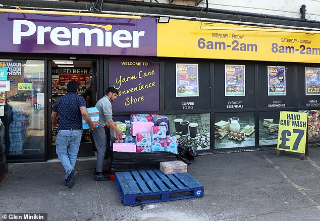 Irslan and Irfan (pictured) applied for skilled worker visas to work at this Stockton Premier shop, which is owned by their older brother, Adnan. All three came to Britain from Pakistan