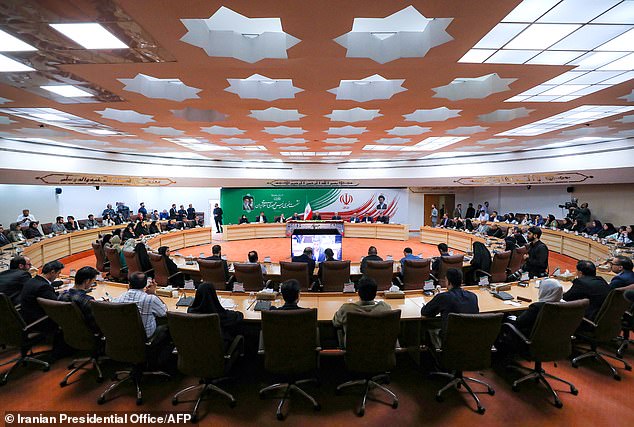 Iran's President Masoud Pezeshkian (center, back) attending a press conference in the capital Tehran, on Saturday