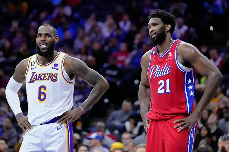 Los Angeles Lakers' LeBron James and Philadelphia 76ers' Joel Embiid play during an NBA basketball game, Friday, Dec. 9, 2022, in Philadelphia. (AP Photo/Matt Slocum, File)