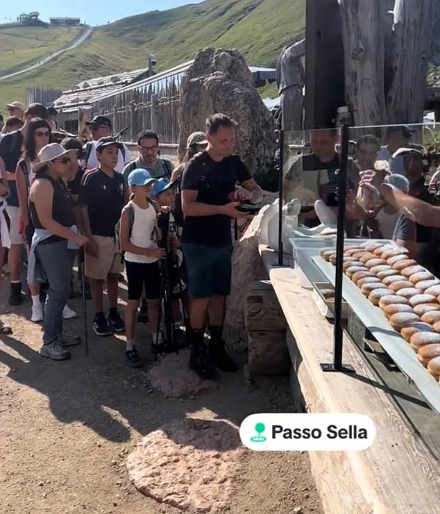 Tourists swamp Dolomites beauty spot with 'crazy' queues forming for local delicacy - as Italian mountains groan under pressure from visitor invasion