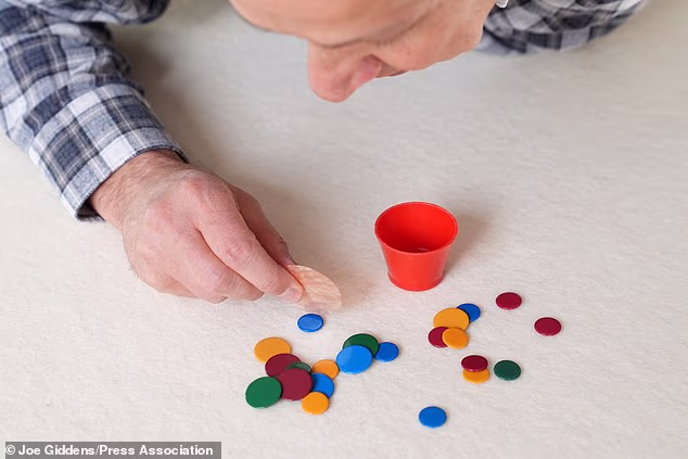 Tiddlywinks is a game in which players try to get small plastic discs into a cup by pressing one piece against another to make it fly through the air