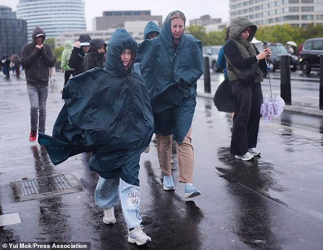People walking in the rain on Westminster Bridge in London