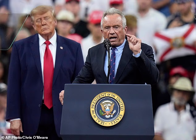President Donald Trump (left) stands alongside Health and Human Services Secretary Robert F. Kennedy Jr.  (right) at a Florida rally on Friday, where he told the crowd that Kennedy had the body of a '30-year-old'