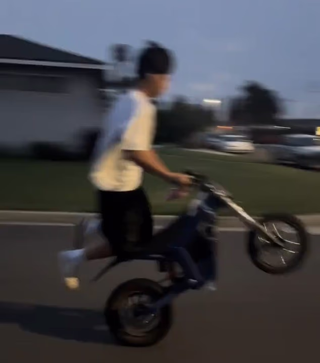 In one clip, the youngster is seen balancing himself on the rear of an electric motorbike while not wearing a helmet