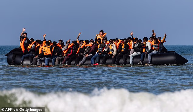 Migrants onboard a smuggler's boat off the beach of Equihen-Plage, northern France
