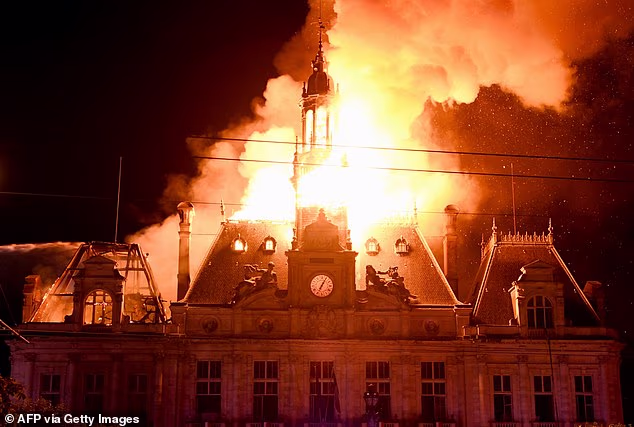 Fire burns the city hall after a group of individuals forced entry into the building during ongoing protest action against the "high cost of living", in Limoges, central France on October 17