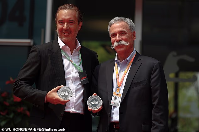 Chase Carey (R), CEO of the Formula One Group and Rosland Capital CEO Marin Aleksov (L) hold medals during a celebration of the 1000th F1 Grand Prix Coin of the Chinese Formula One Grand Prix at the Shanghai International circuit in Shanghai, China on April 2019. Rosland Capital sold precious metal coins featuring limited-edition gold and silver commemorative circuit coins