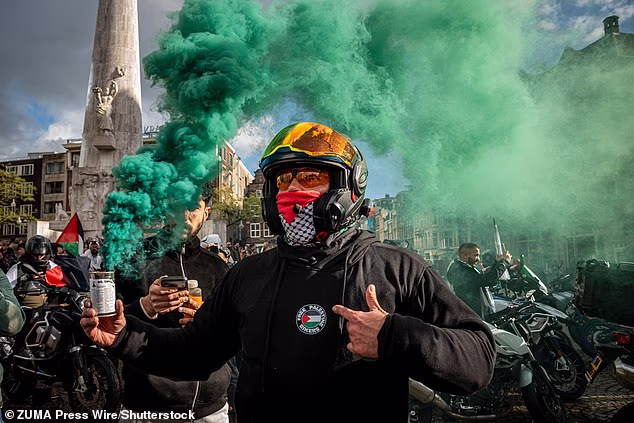Bikers for Palestine members set off smoke flares at Dam Square in Amsterdam, North Holland, The Netherlands, October 11