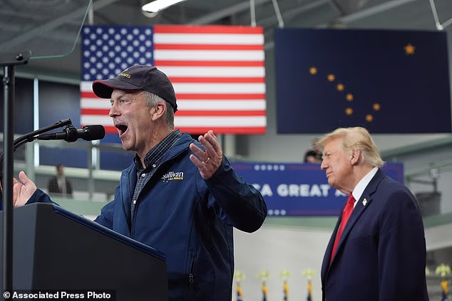 President Donald Trump listens as Sen. Dan Sullivan, R-Alaska, speaks at a campaign rally at the Curtis D. Menard Memorial Sports Center in Wasilla, Alaska on Tuesday